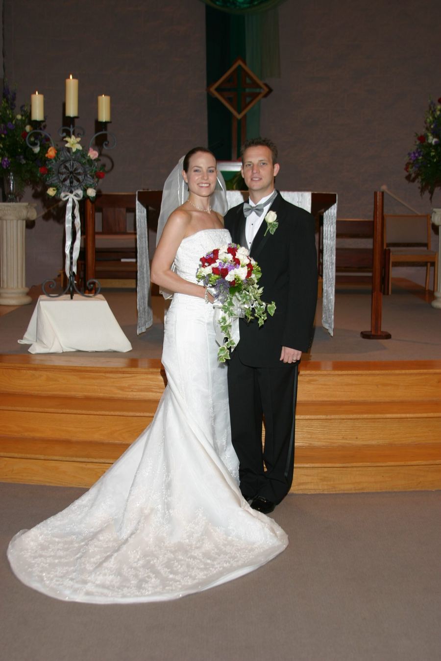 Bride and groom standing at the altar of a church after their ceremony